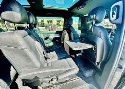 Luxury car interior with leather seats and touchscreen display, Geelong Luxury Transport offers technology and entertainment for an exciting journey.